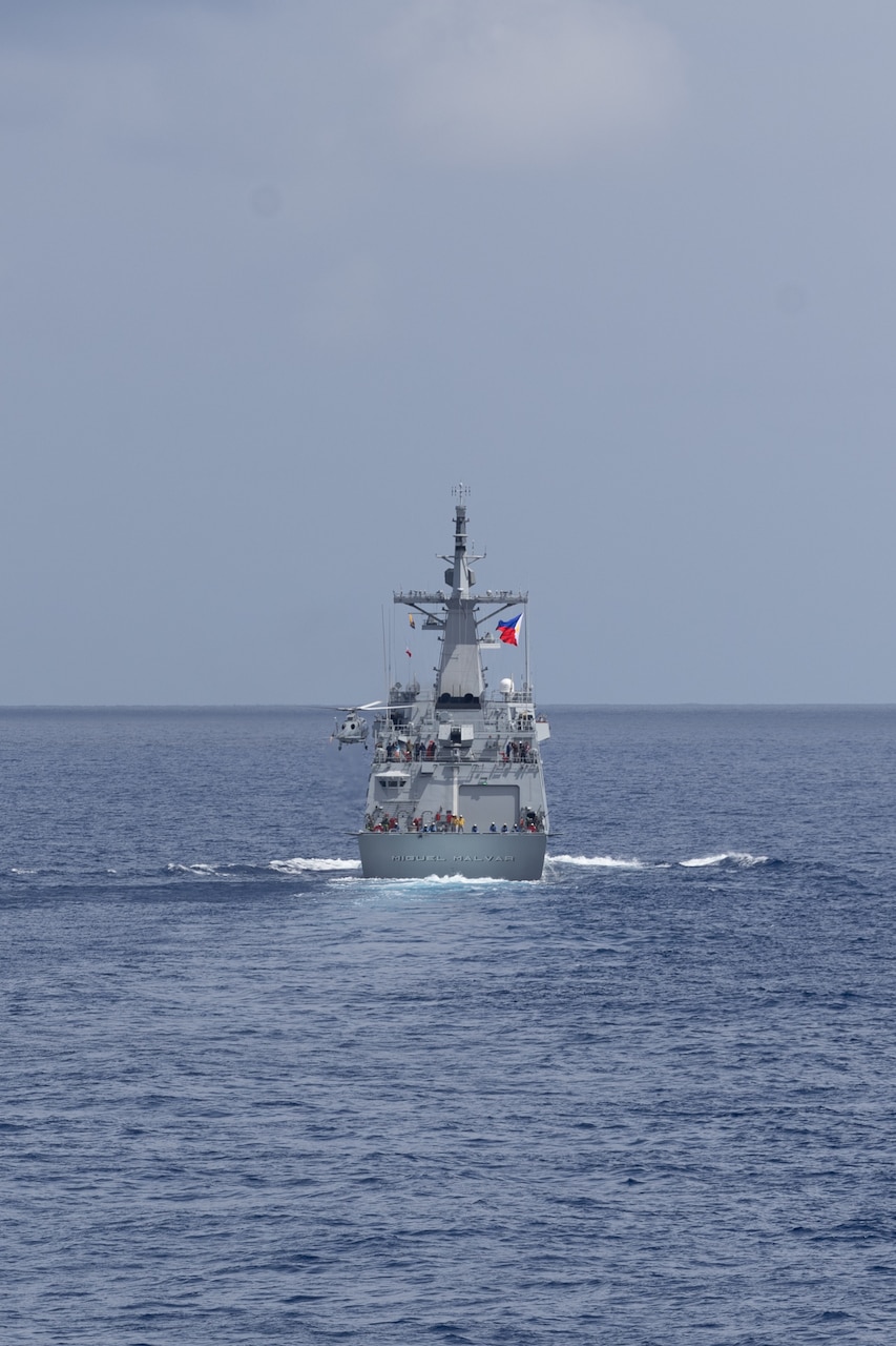 The first-in-class Philippine Navy (PN) guided-missile frigate BRP Miguel Malvar (FFG-06) conduct flight operations during a photo exercise with the Arleigh Burke-class guided-missile destroyer USS Curtis Wilbur (DDG 54) in the South China Sea, July 16, 2025.