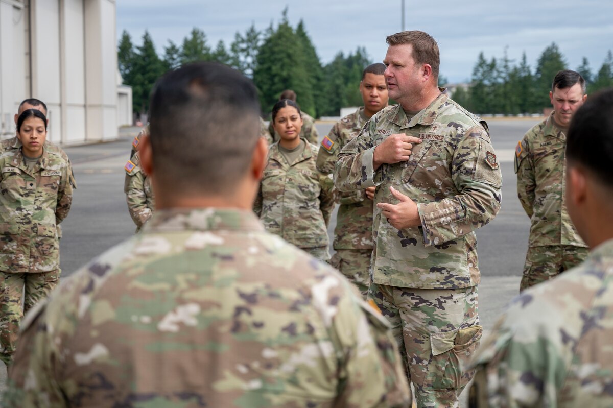U.S. Air Force Lt. Col. Kip Averett, Team McChord wing chaplain, highlights chaplains’ and religious affairs team members’ roles during the dignified transfer ramp ceremony process at Joint Base Lewis-McChord, Washington, July 10, 2025.