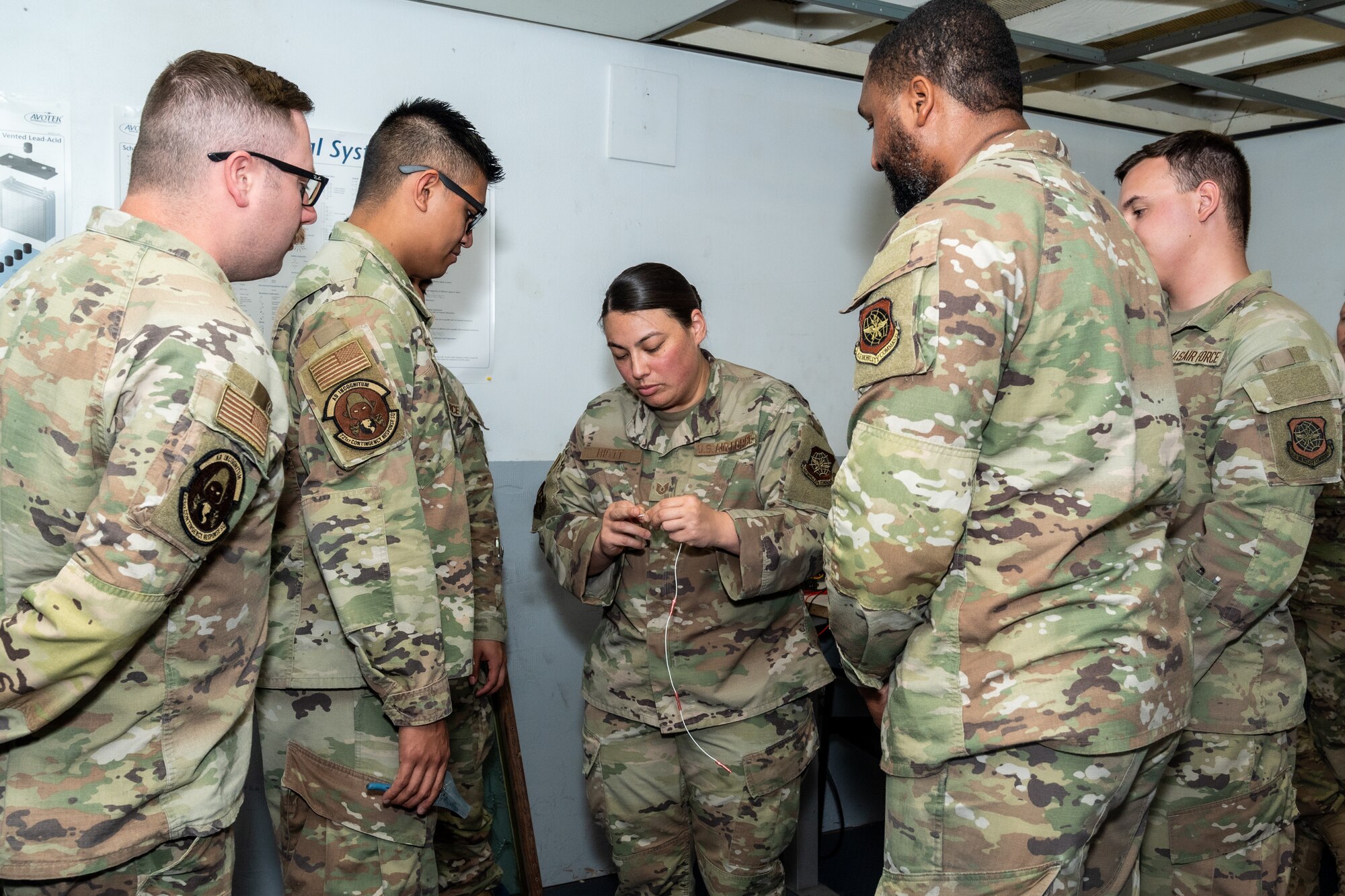 Instructor explains wiring to Airmen
