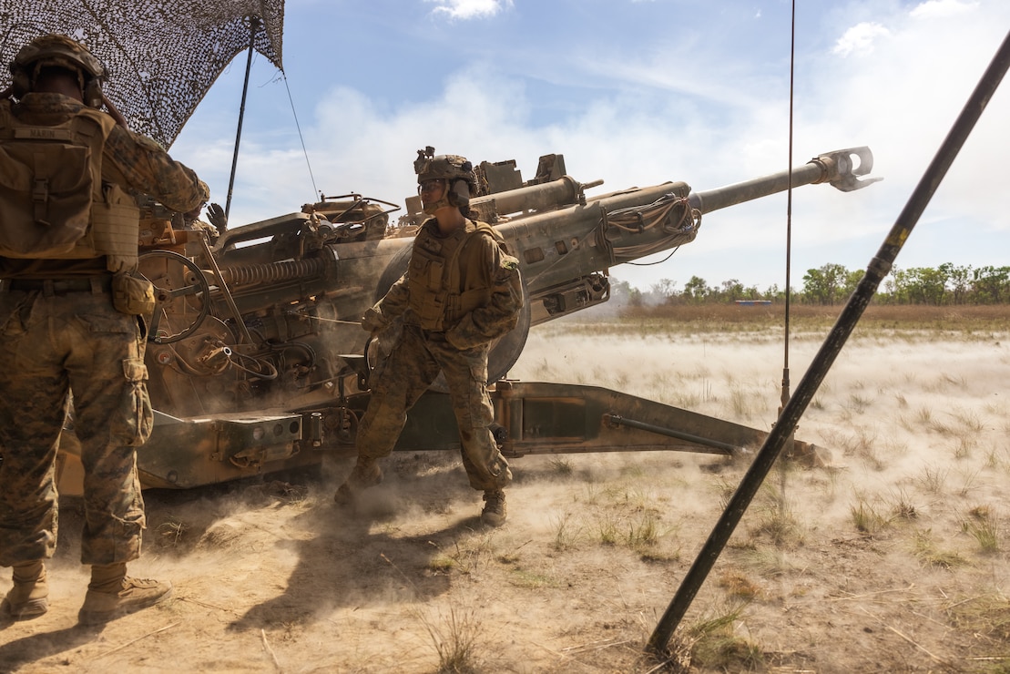 U.S. Marine Corps Cpl. Cindy Bollos, right, an ammo chief, and Lance Cpl. Jeziel Marin, a field artillery cannoneer, both with Kilo Battery, 3rd Battalion, 11th Marine Regiment, Marine Rotational Force – Darwin 25.3, fire an M777 Howitzer during Talisman Sabre 25 in the Northern Territory, Australia, July 13, 2025.
