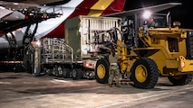 U.S. Airmen load cargo onto a Boeing 747 aircraft