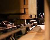 U.S. Air Force Staff Sgt. Alyssa Stokley, 325th Logistics Readiness Squadron air transportation function craftsman, directs a forklift driver to load cargo onto a Tunner 25K loader at Tyndall Air Force Base, Florida.