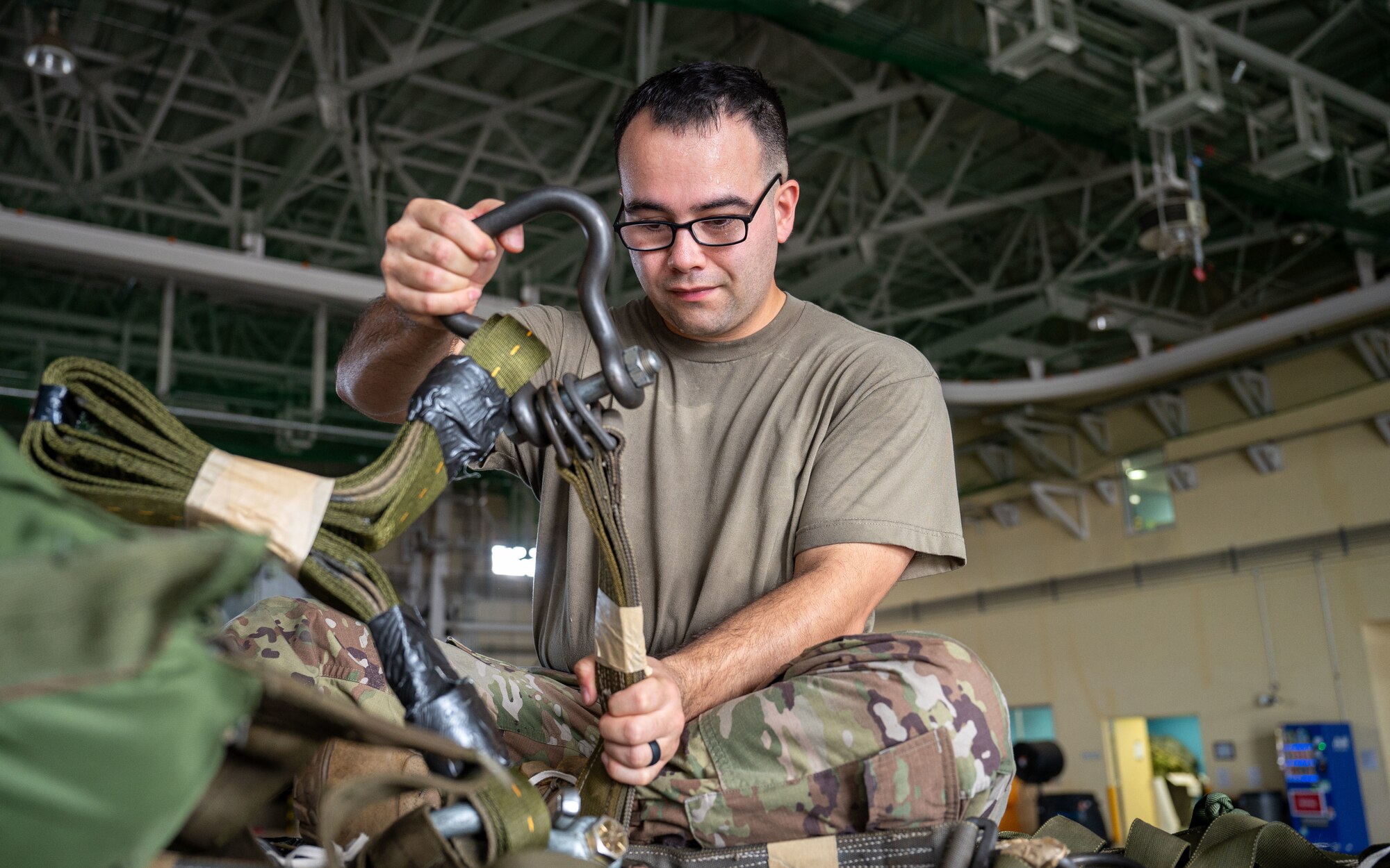 A military member secures a bundle of equipment.