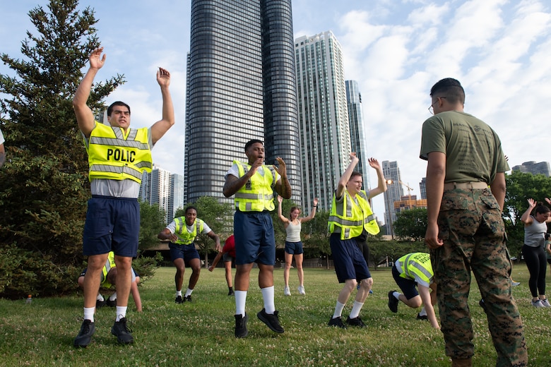 U.S. Marine Corps Lance Cpl. Rafael Garcia, an administrative specialist assigned to Special Purpose Marine Air-Ground Task Force-250, leads a physical training event with Chicago Police Department recruits at DuSable Harbor during Marine Week Chicago, July 10, 2025. The Chicago Police Department joined a physical training session led by Marines to celebrate the upcoming 250th anniversary of the Marine Corps.