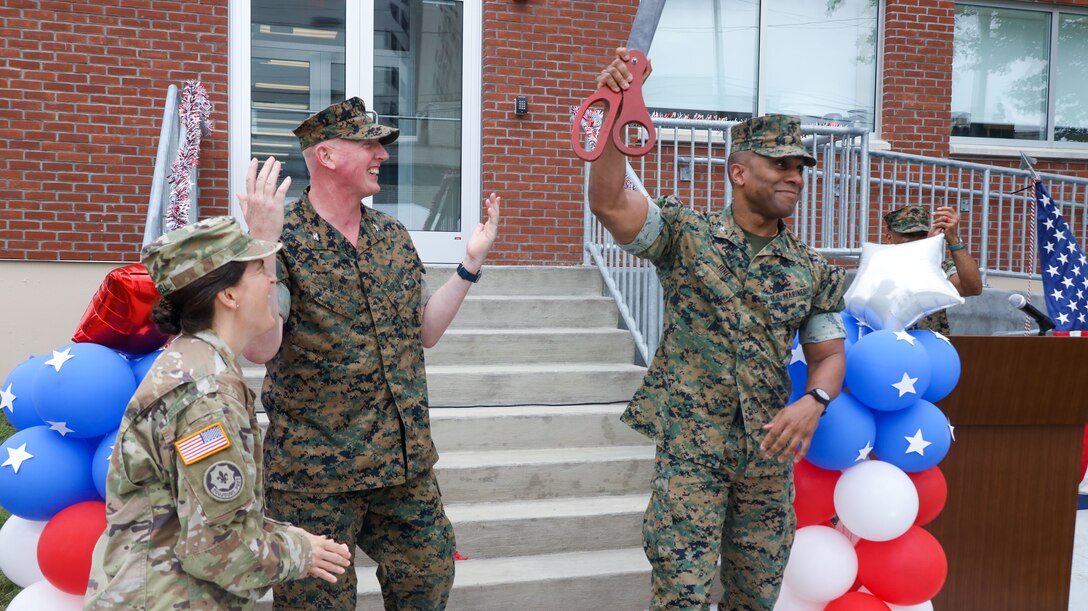 U.S. Marine Corps Col. Robert Jones (right), incoming commanding officer of 1st Marine Corps District (MCD) cerebrates the cutting of the ceremonial ribbon during the opening ceremony of the Robert Mullan Center, Fort Hamilton, New York, July 17, 2025. The ceremony was held to honor the opening of 1st Marine Corps District’s new headquarters after relocating from Garden City, New York.