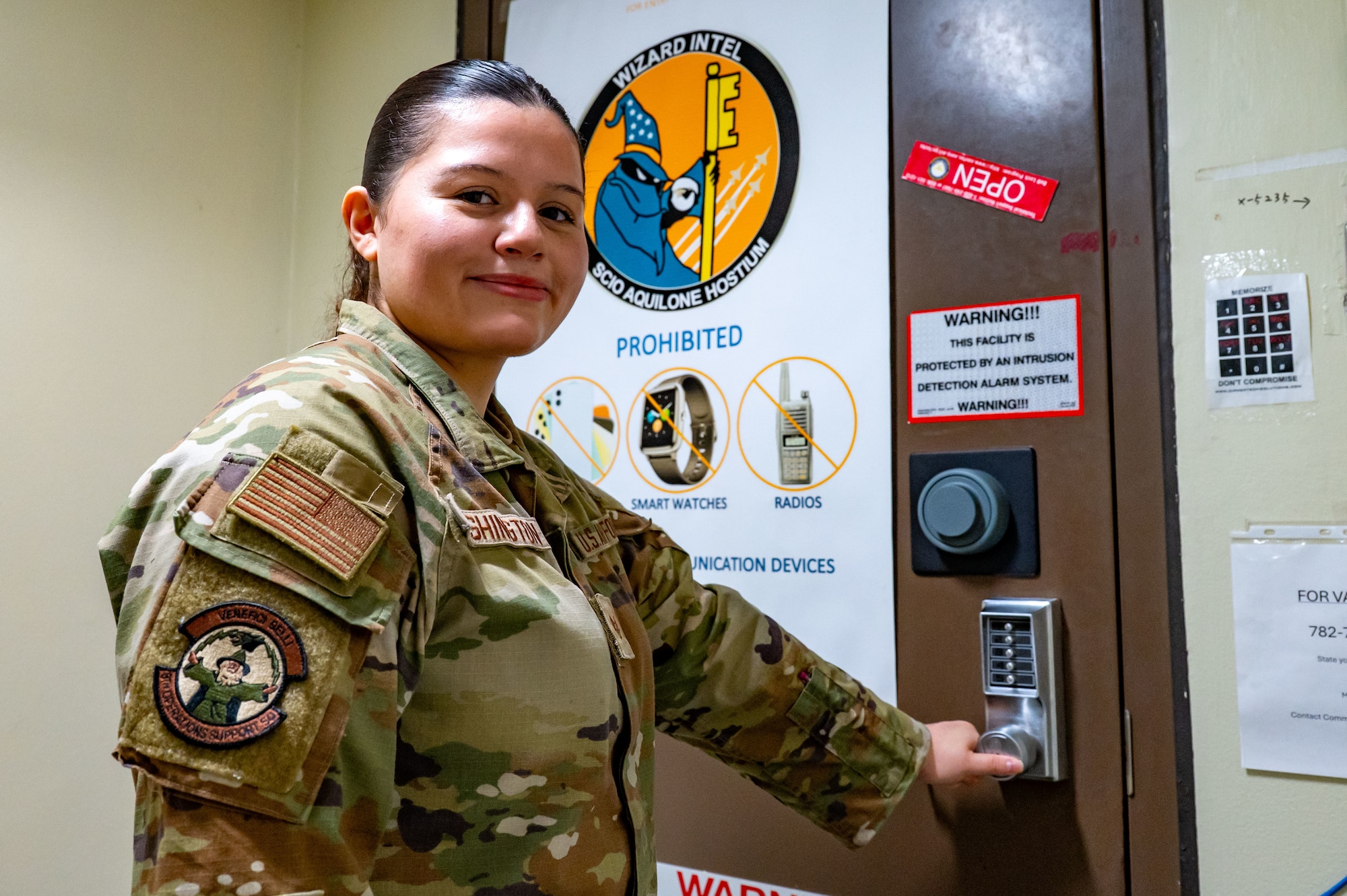 U.S. Air Force Staff Sgt. Alexandria Washington opens the door to her office.