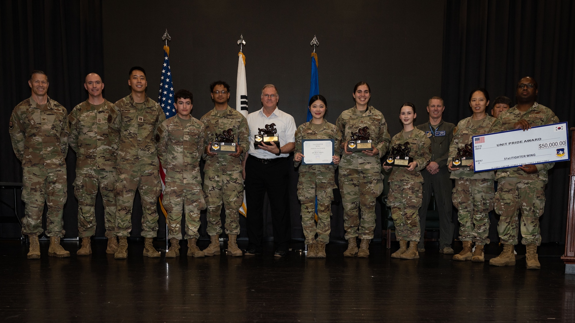 The 51st Fighter Wing 2nd Quarter Award winners pose for a group photo at Osan Air Base, Republic of Korea, July 18, 2025. The awards ceremony recognizes outstanding performers throughout the wing supporting the "Fight Tonight" mission. (U.S. Air Force photo by Senior Airman Rome Bowermaster)