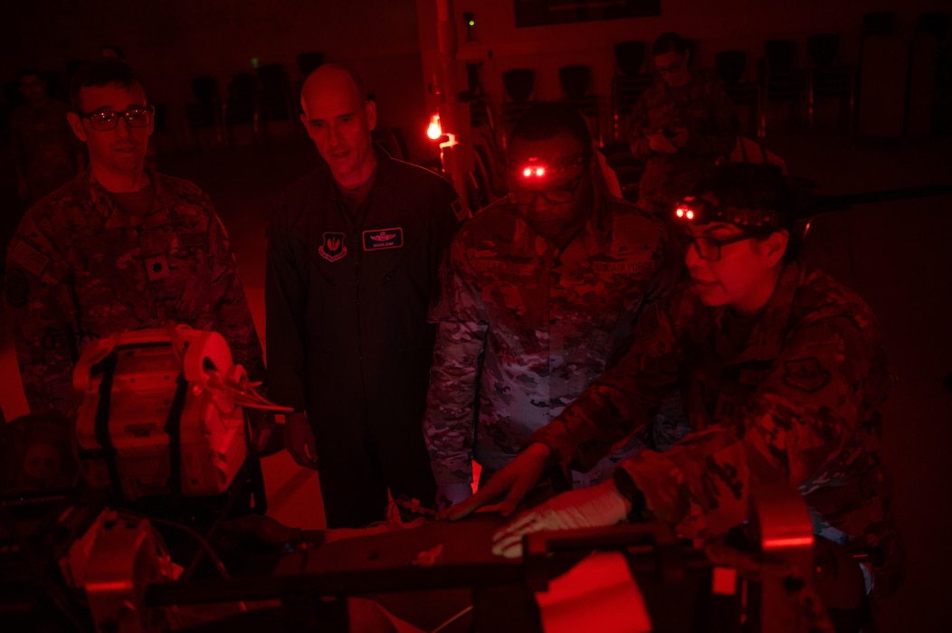 U.S. Air Force Col. Nathan D. Bump, 86th Airlift Wing deputy commander, and Chief Master Sgt. Clifford L. Lawton, 86th AW command chief, work alongside critical care air transport team members during a wing immersion.