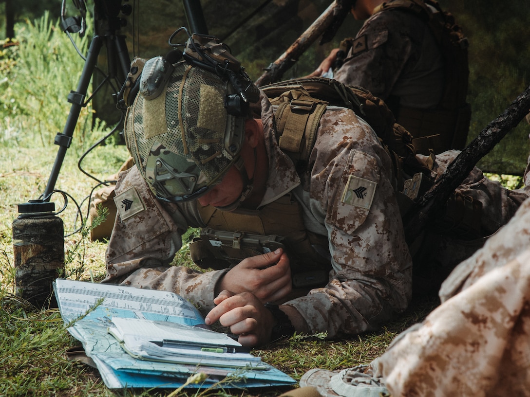 U.S. Marine Corps Sgt. Jacob Anderson, a joint terminal attack controller with the 22nd Marine Expeditionary Unit (Special Operations Capable), looks at grids on a map during Supporting Arms Coordination Center Exercise in support of Composite Training Unit Exercise on Marine Corps Base Camp Lejeune, July 11, 2025. During COMPTUEX, the IWO ARG and 22nd MEU (SOC), refine tactics, techniques, and procedures to execute warfighting functions that enhance operational readiness and lethality as a unified IWOARG/22 MEU(SOC) team. (U.S. Marine Corps photo by Sgt. Tanner Bernat)