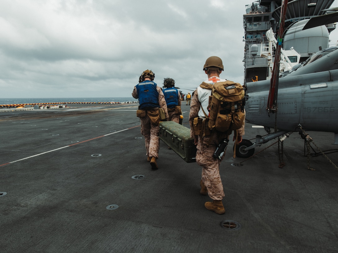 U.S. Marine Corps Low Altitude Air Defense (LAAD) gunners with Marine Medium Tiltrotor Squadron 263 (Reinforced), 22nd Marine Expeditionary Unit (Special Operations Capable), carry FIM-92 Stingers during integrated live fire exercise aboard the Wasp-class amphibious assault ship USS Iwo Jima (LHD 7), in support of Composite Training Unit Exercise while underway in the Atlantic Ocean, July 5, 2025. During COMPTUEX, the IWO ARG and 22nd MEU(SOC), refine tactics, techniques, and procedures to execute warfighting functions that enhance operational readiness and lethality as a unified IWOARG/22 MEU(SOC) team. (U.S. Marine Corps photo by Sgt. Tanner Bernat)