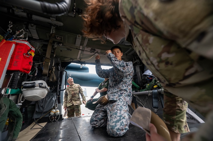A Japan Air Self-Defense Force Airman assigned to the Air Rescue Wing displays the internals of a UH-60J helicopter for a cross-unit static display and capability exchange during exercise Resolute Force Pacific (REFORPAC) 2025 at Misawa Air Base, July 15, 2025.
