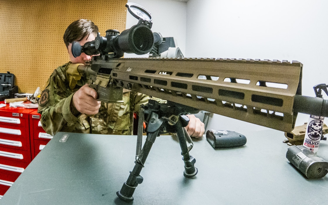 Airman looking through rifle scope