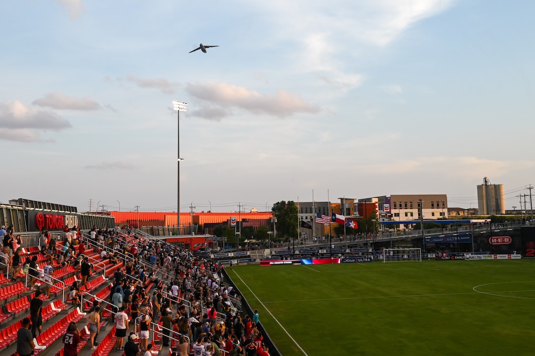 Fans cheer as a 433rd Airlift Wing C-5M Super Galaxy soars over Toyota Field during the first flyover by a military aircraft at a San Antonio FC soccer match in San Antonio, Texas, July 12, 2025.
