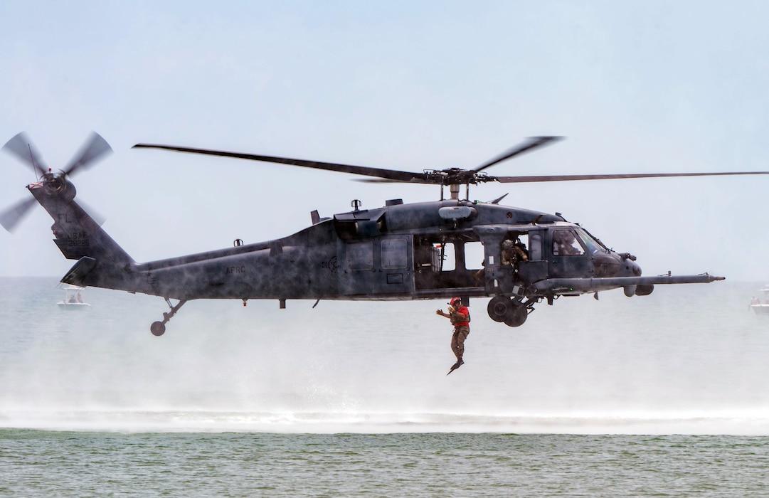 Airman jumping out of helicopter into water