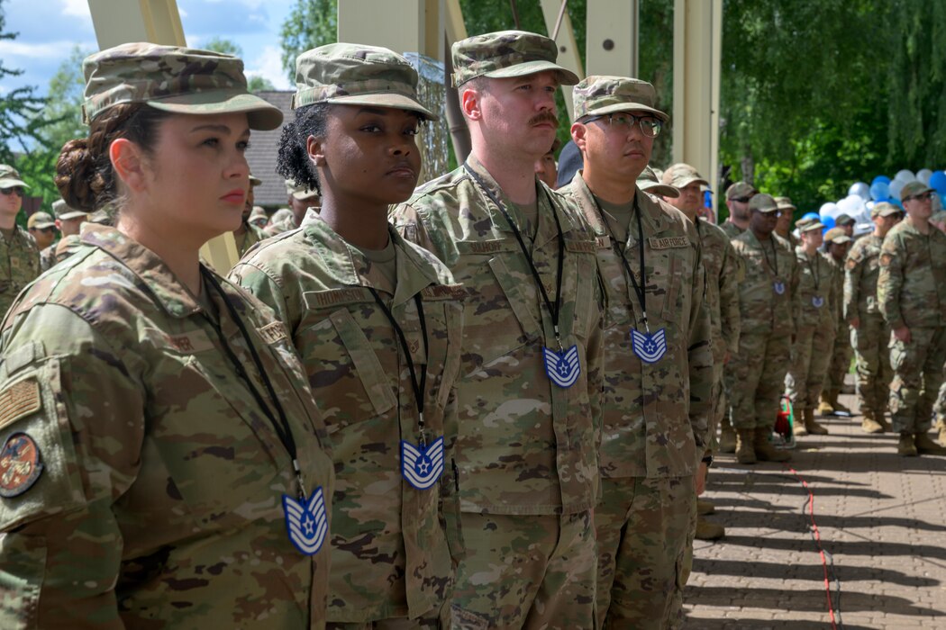 A group of people standing at attention in line.