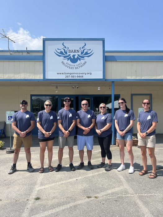 Mombers of the Company Grade Officers' Council pose outside the Bangor Area Recovery Network.