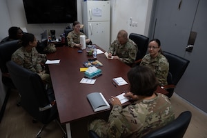 The 379th Expeditionary Medical Group Mental Health Team gathers for a meeting within the U.S. Central Command area of responsibility, July 14, 2025. The Mental Health office aids in the success of the base’s mission by providing direct support for the mental well being of personnel within the AOR. (U.S. Air Force photo by Senior Airman Dieondiere Jefferies)