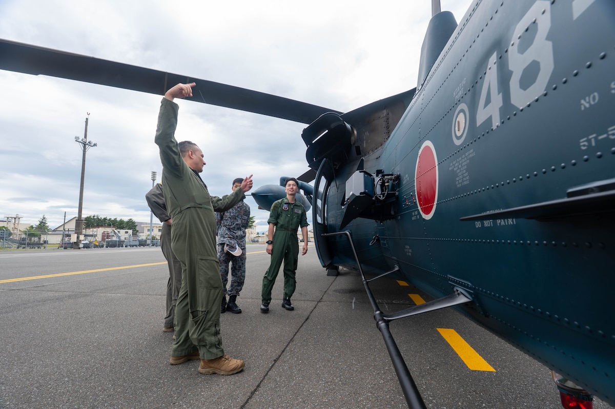 U.S. Air Force Airmen assigned to the 102nd and 130th Air Rescue Squadrons are shown a Japan Air Self-Defense Force (JASDF) Air Rescue Wing UH-60J helicopter for a cross-unit static display and capability exchange during exercise Resolute Force Pacific (REFORPAC) 2025 at Misawa Air Base, July 15, 2025.