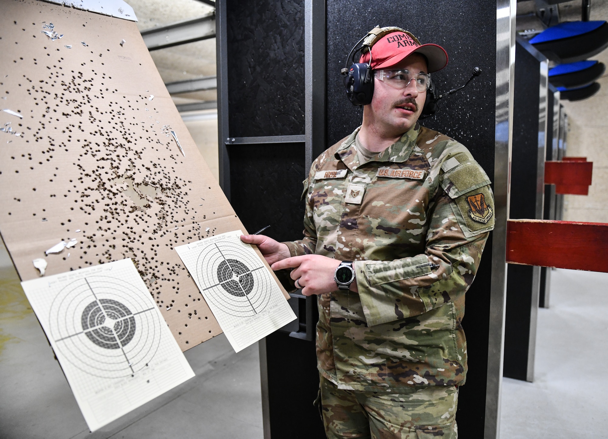 Staff Sergeant Karic Hierl, 55th Security Forces Squadron combat arms training and maintenance instructor, inspects targets during a training session on Offutt Air Force Base, June 4, 2025. CATM is a training program that focuses on equipping Air Force personnel with the skills and knowledge to safely and effectively use weapons. (U.S Air Force photo by Chad Watkins)