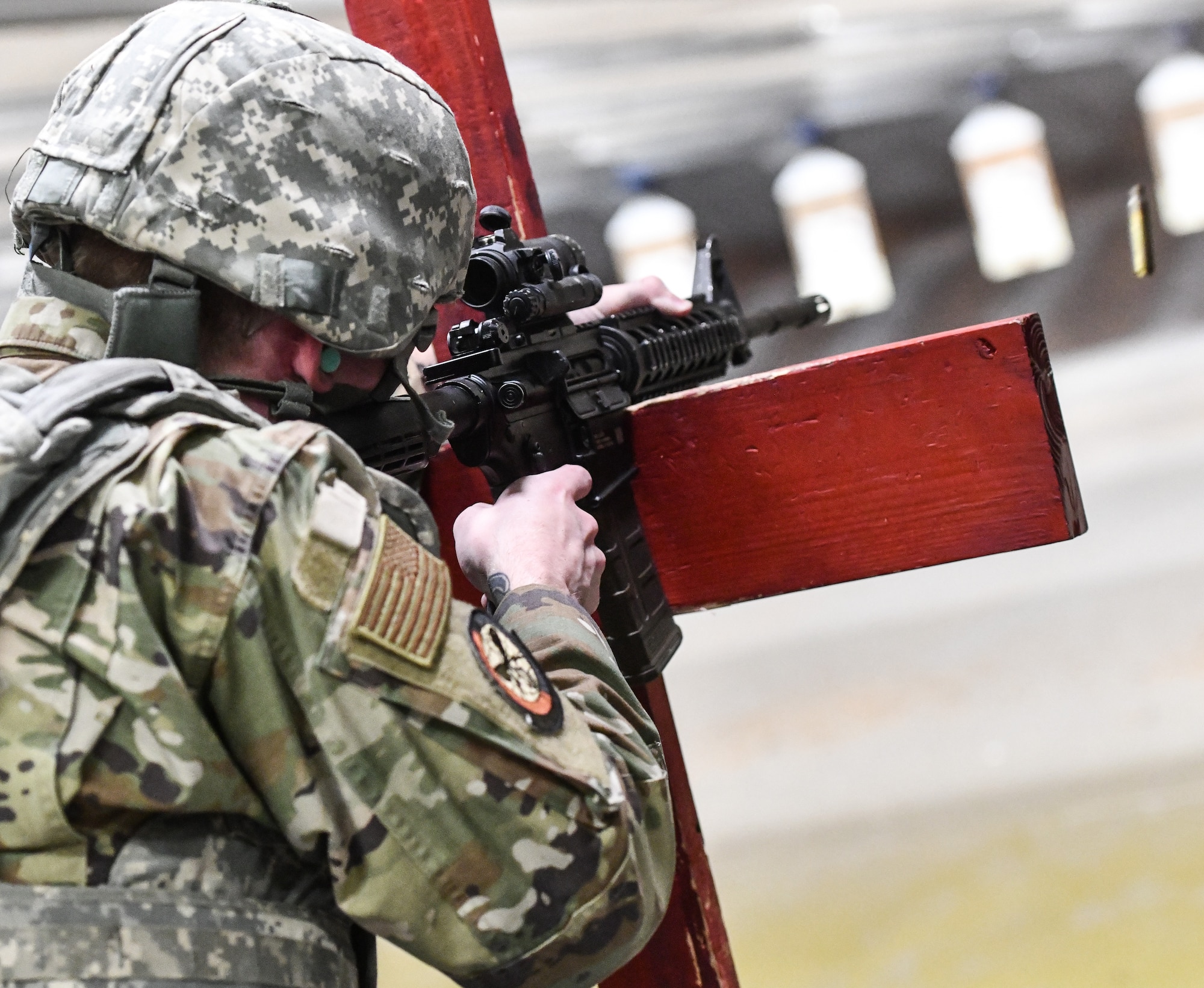 Airmen fire the M-4 rifle in the over barricade position at Offutt Air Force Base's combat arms training and maintenance class, June 4, 2025. CATM teaches all Airmen, from those with no weapons experience to those with years of experience, how to correctly and safely use many different types of firearms.(U.S. Air Force photo by Chad Watkins)