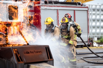 U.S. Air Force firefighters assigned to the 169th Civil Engineer Squadron’s fire department and the 374th Civil Engineer Squadron’s fire department conduct car burn procedures during a deployment for a training course at Yokota Air Base, Japan, July 5, 2025.