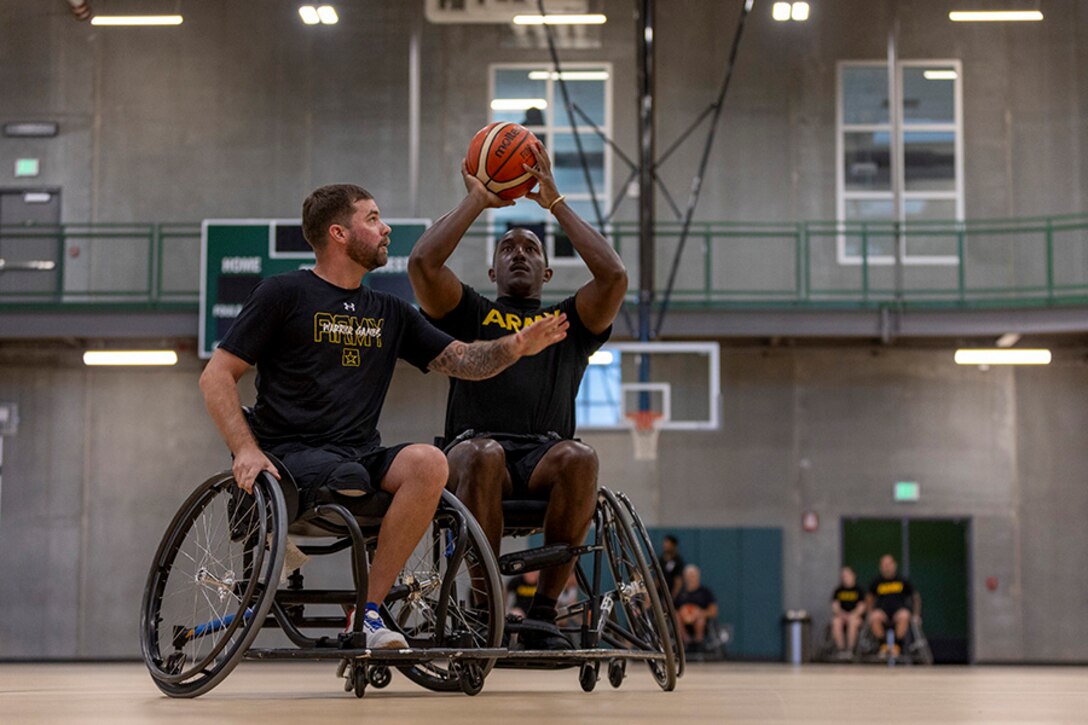 U.S. Army Staff Sgt. John Britton, left, attempts to block Master Sgt. Earlie Brown while conducting drills at the wheelchair basketball practice, during the 2025 Department of Defense Warrior Games practice sessions at Fort Carson, Colorado, July 14, 2025.