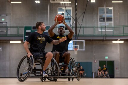 U.S. Army Staff Sgt. John Britton, left, attempts to block Master Sgt. Earlie Brown while conducting drills at the wheelchair basketball practice, during the 2025 Department of Defense Warrior Games practice sessions at Fort Carson, Colorado, July 14, 2025.