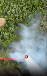 Task Force Aviation of Kentucky National Guard, assigned to the 256th IBCT and KFOR RC-E drops water over a wildfire threatening the Devic Monastery in Kosovo, July 8, 2025.
