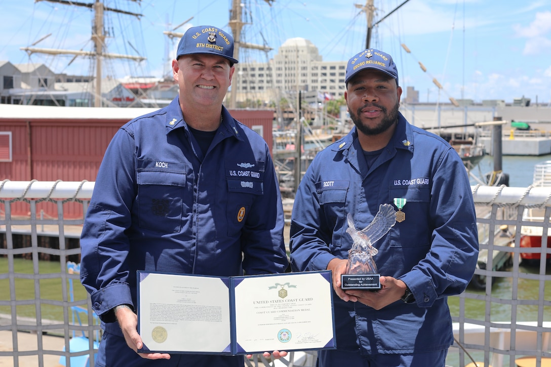 Master Chief Petty Officer Michael Koch, command master chief, Coast Guard Heartland District, and Petty Officer 1st Class Cody Scott, a storekeeper assigned to Coast Guard Cutter Reliance (WMEC 615), pose for a photo aboard the cutter in Galveston, Texas, June 24, 2025. Scott was formally recognized as the Coast Guard District Heartland Enlisted Person of the Year and awarded the Coast Guard Commendation Medal for his superior performance. (U.S. Coast Guard photo by Ensign Sarah Kaleta)