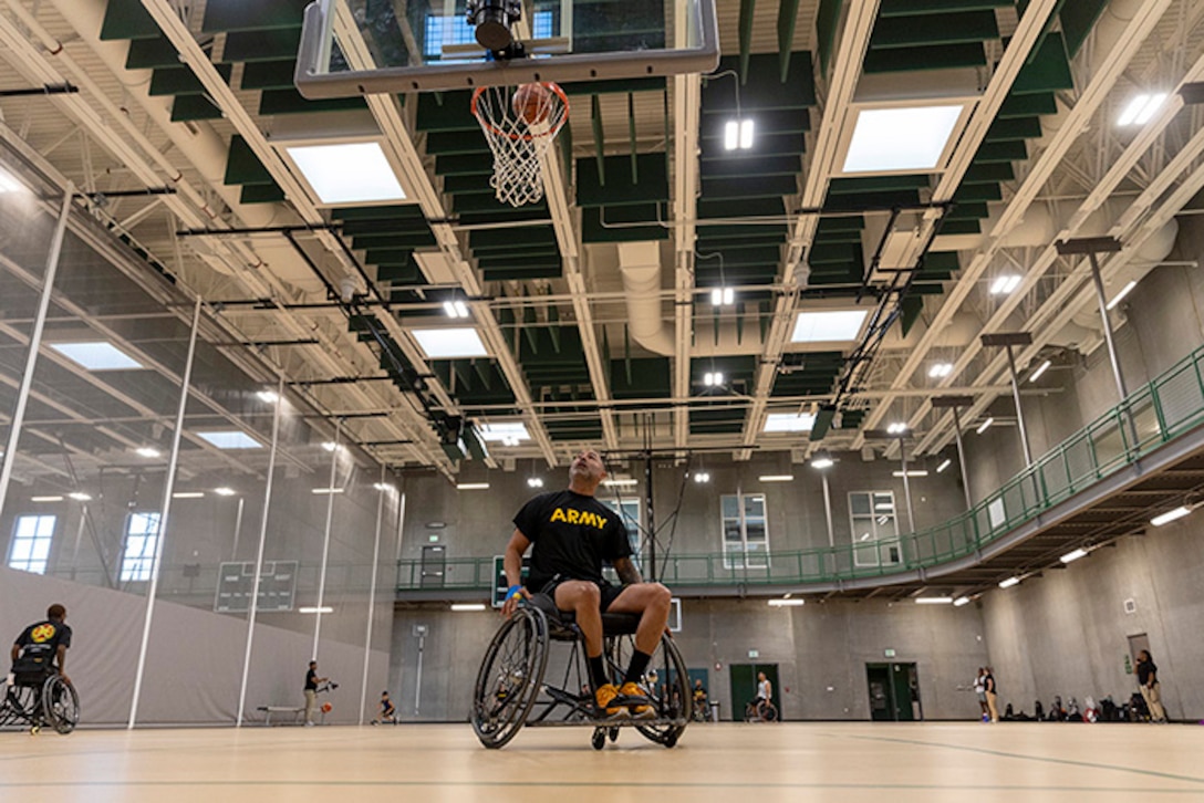 U.S. Army Capt. Carlos Rivera shoots the ball at wheelchair basketball practice during the 2025 Department of Defense Warrior Games practice sessions at Fort Carson, Colorado, July 14, 2025.