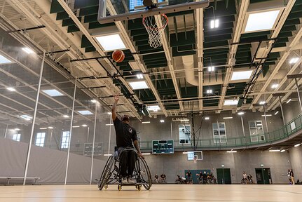 U.S. Army Staff Sgt. Allaijah Churchwell shoots the ball at wheelchair basketball practice during the 2025 Department of Defense Warrior Games practice sessions at Fort Carson, Colorado, July 14, 2025.