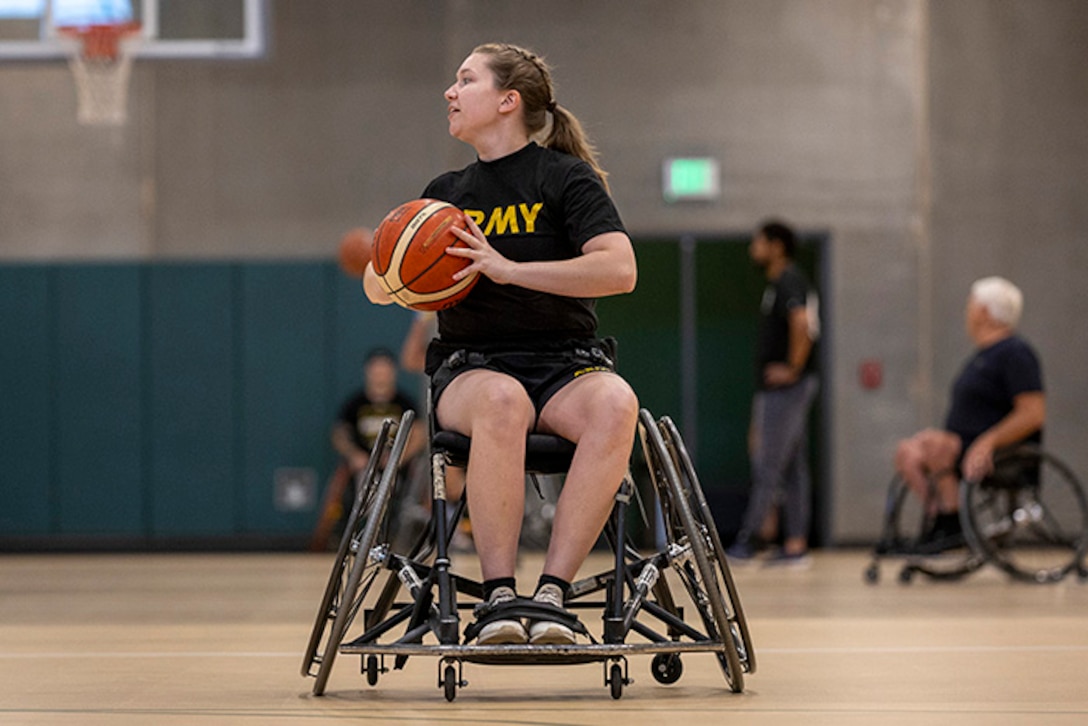 U.S. Army Capt. Samantha Frey participates in passing drills at wheelchair basketball practice during the 2025 Department of Defense Warrior Games practice sessions at Fort Carson, Colorado, July 14, 2025.