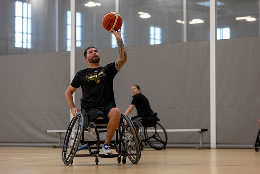 U.S. Army Staff Sgt. John Michael Britton shoots the basketball while conducting drills at wheelchair basketball practice during the 2025 Department of Defense Warrior Games practice sessions at Fort Carson, Colorado, July 14, 2025.
