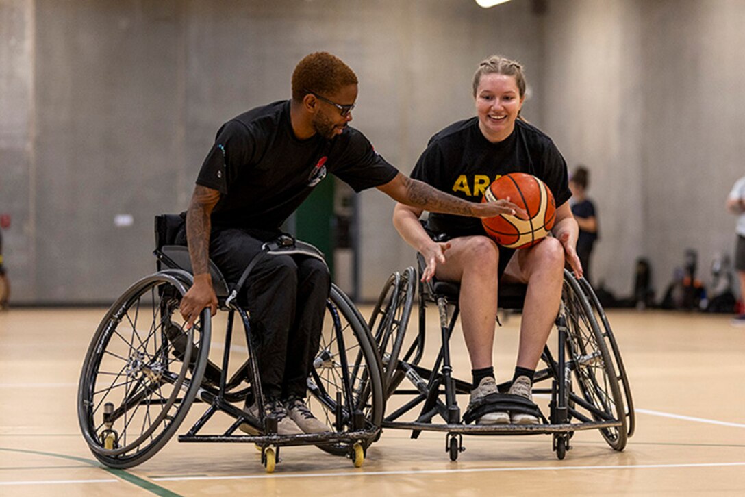 U.S. Army Staff Sgt. Allaijah Churchwell and Capt. Samantha Frey runs drills at the wheelchair basketball practice, July 14, at Reid Arena, Colorado College.