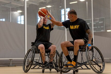 U.S. Army Staff Sgt. Tyler Pollard, left, shoots the ball while Capt. Carlos Rivera attempts to block while conducting drills at wheelchair basketball practice during the 2025 Department of Defense Warrior Games practice sessions at Fort Carson, Colorado, July 14, 2025.