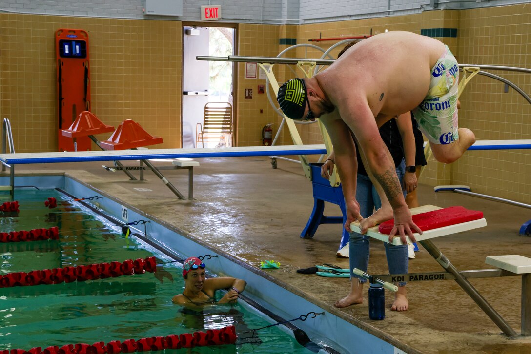 U.S. Army Sgt. 1st Class Adam Proctor prepares to dive at swimming practice during the 2025 Department of Defense Warrior Games practice sessions at Fort Carson, Colorado, July 13, 2025.