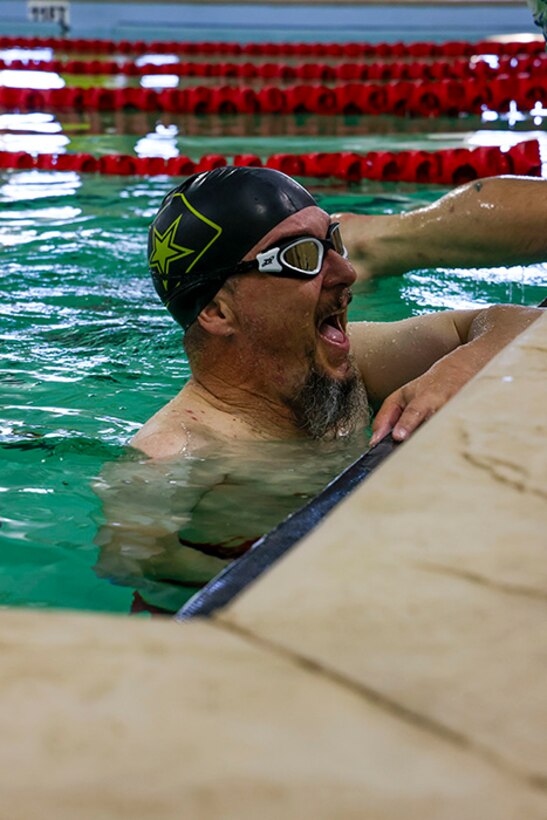 U.S. Army veteran Jeremy Ditlevson laughs with others at swimming practice during the 2025 Department of Defense Warrior Games practice sessions at Fort Carson, Colorado, July 13, 2025.