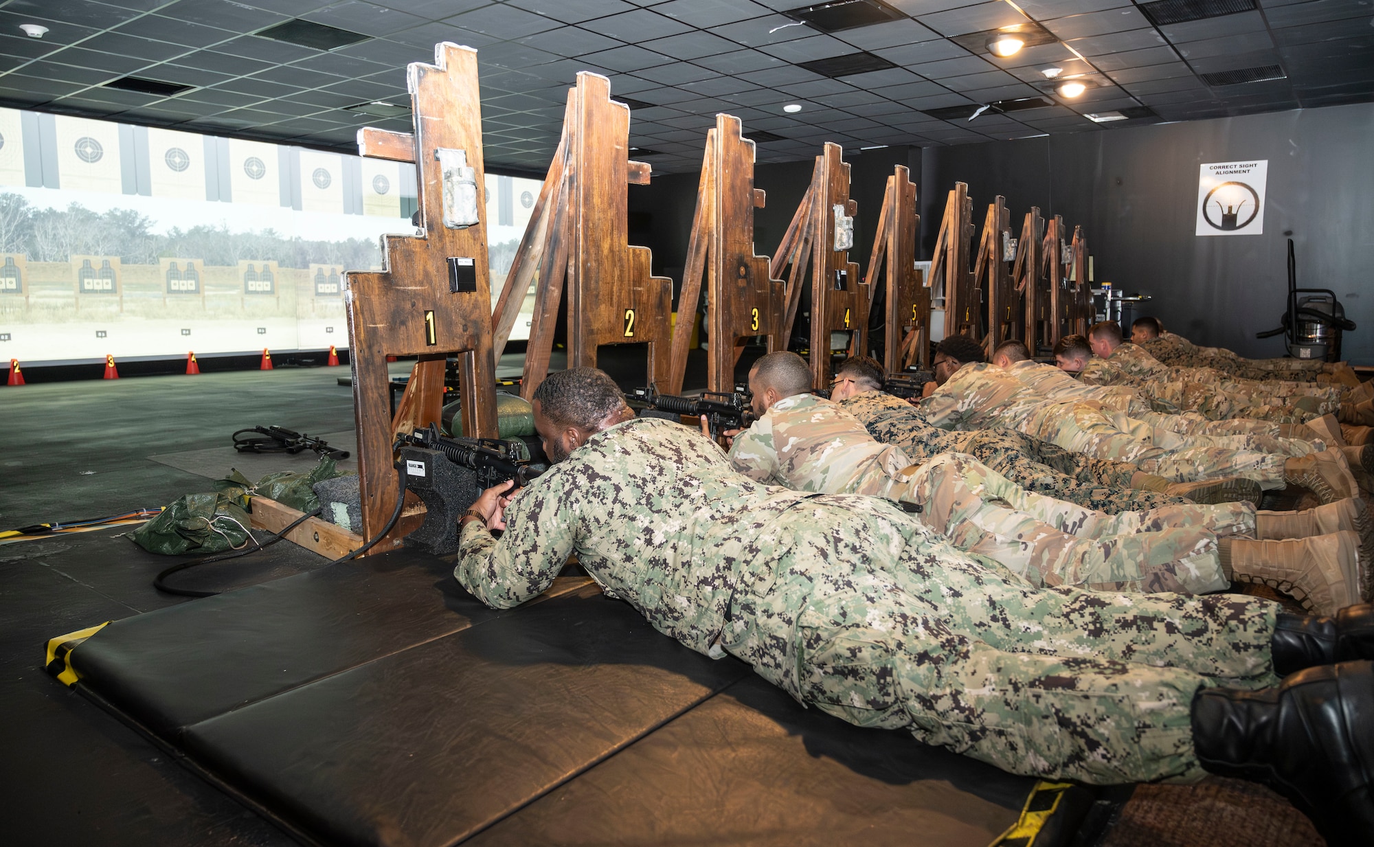 Service members participate in M4 carbine qualification during electronic simulation training hosted by Army Support Activity as part of the Leading Edge course at Joint Base McGuire-Dix-Lakehurst, N.J., June 26, 2025.  Leading Edge is a biannual joint operation training course offered to service members between the ranks of E-4 to E-6 from all military branches to enhance leadership, interoperability, and understanding of each service’s capabilities. (U.S. Air Force photo by Susan Moriarty) 