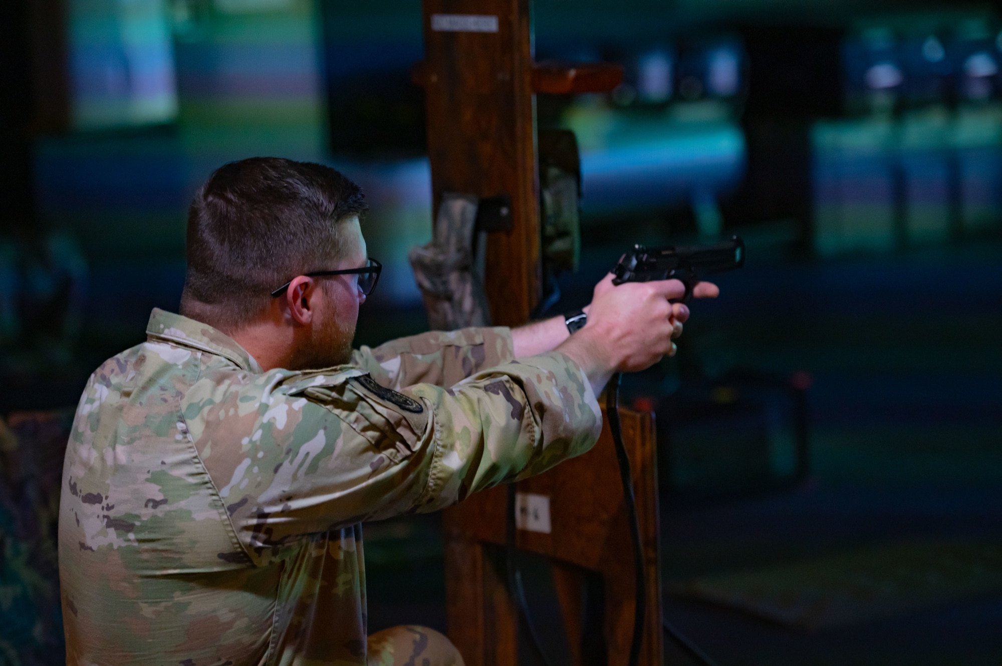 U.S. Air Force Staff Sgt. Codale Vance, 521st Contingency Response Squadron Airfield Management craftsman, uses a training Beretta M9 handgun during electronic simulation training hosted by the U.S. Army Support Activity, Fort Dix as part of the Leading Edge course at Joint Base McGuire-Dix-Lakehurst, N.J., June 26, 2025. .  Leading Edge is a biannual joint operation training course offered to service members between the ranks of E-4 to E-6 from all military branches to enhance leadership, interoperability, and understanding of each service’s capabilities. (U.S. Air Force photo by 2d Lt. Gabriel Davenport)