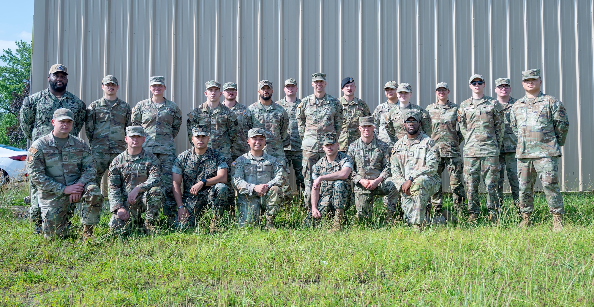 U.S. Army Col. Bryan Dunker (standing in center), Joint Base McGuire-Dix-Lakehurst Deputy commander and Army Support Activity commander, poses with service members of the Leading Edge course at Joint Base McGuire-Dix-Lakehurst, N.J., June 26, 2025.  Leading Edge is a biannual joint operation training course offered to service members between the ranks of E-4 to E-6 from all military branches to enhance leadership, interoperability, and understanding of each service’s capabilities. (U.S. Air Force photo by Susan Moriarty)