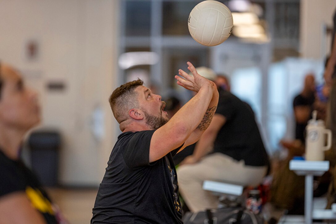 U.S. Army Sgt. 1st Class Adam Proctor prepares to hit the ball while conducting drills at sitting volleyball practice during the 2025 Department of Defense Warrior Games at Fort Carson, Colorado, July 13, 2025.