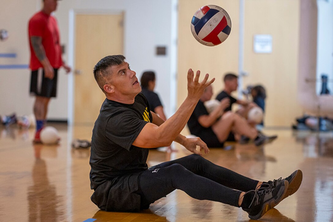 U.S. Army Sgt. 1st Class Alberto Alvarez focuses on the ball while conducting drills at sitting volleyball practice during the 2025 Department of Defense Warrior Games at Fort Carson, Colorado, July 13, 2025.