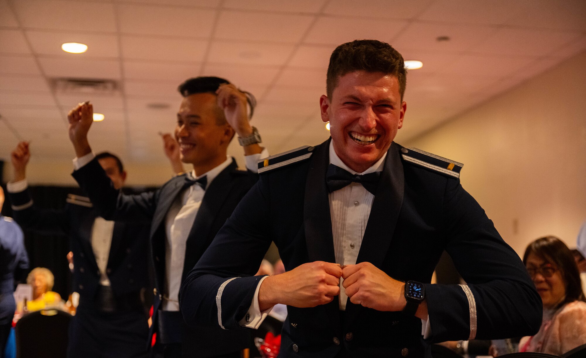 Student pilots from Class 25-12 break their silver wings during their graduation ceremony at Laughlin Air Force Base, Texas, July 17, 2025.  The breaking of silver wings is a tradition dating back to the U.S. Army Air Corps where a pilot's first wings are not to be worn, but broken and given to a loved one. (U.S. Air Force photo by Airman 1st Class Darryl Keith.)