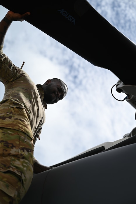 a person checks a helicopter