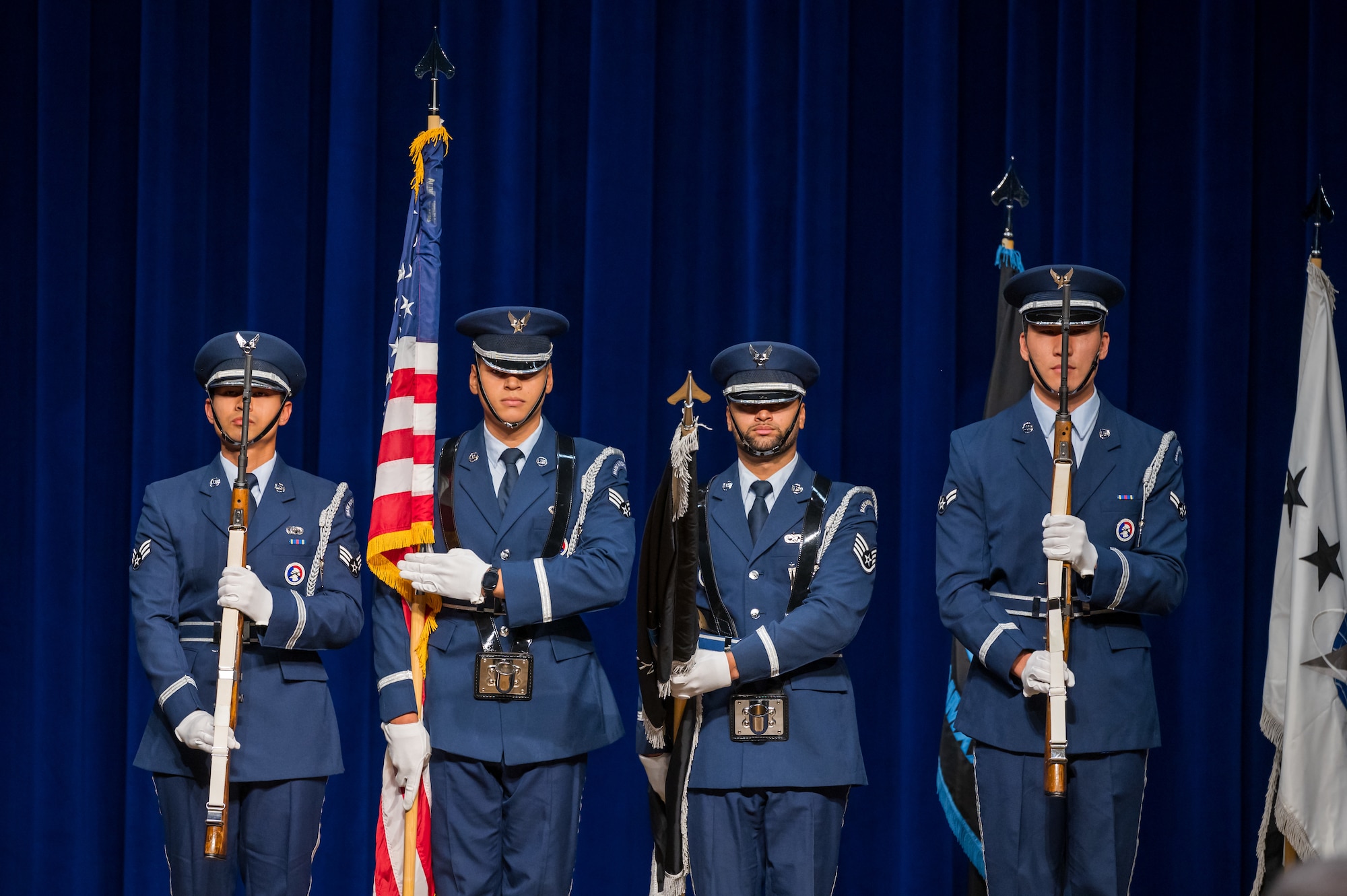 Patrick Space Force’s honor guard present the colors during the national anthem at Space Training and Readiness Command’s change of command ceremony at Patrick Space Force Base. Men standing in uniform with flags.