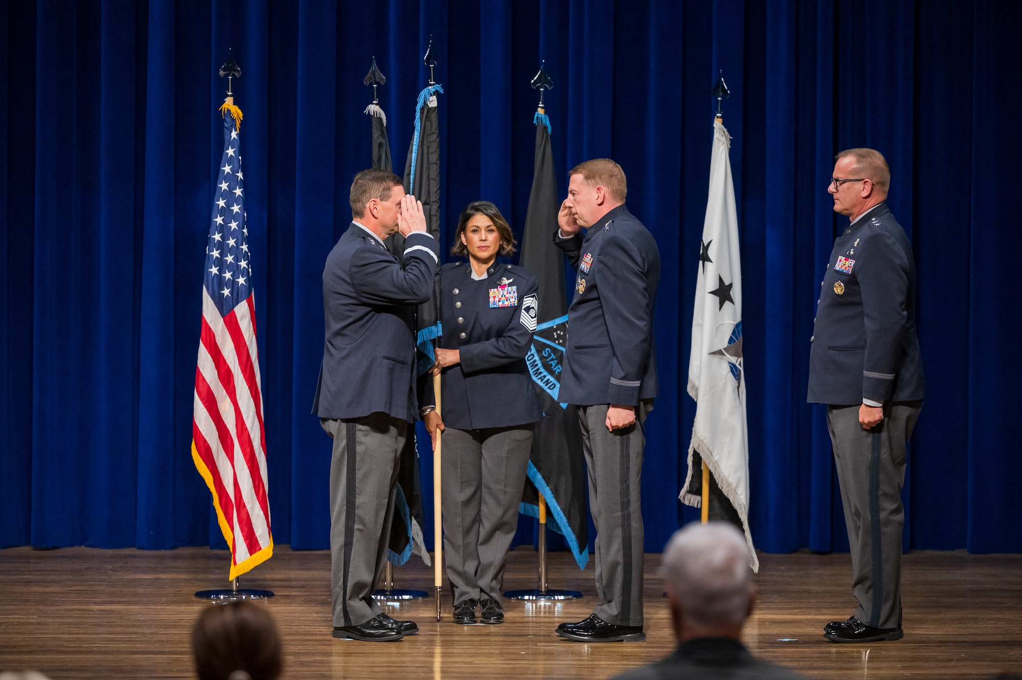 Maj. Gen. James E. Smith renders his first salute - change of command ceremony with flags in back.
