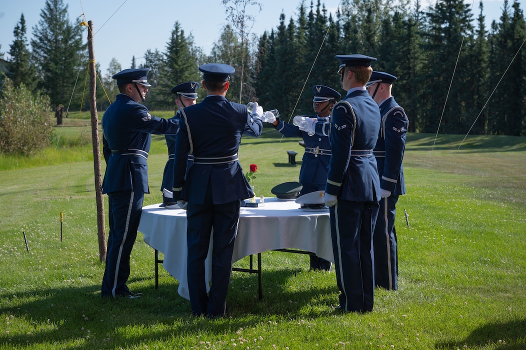 Members of the Eielson Air Force Base Honor Guard turn water glasses upside down during a change of command ceremony at Eielson Air Force Base, Alaska, July 18, 2025.