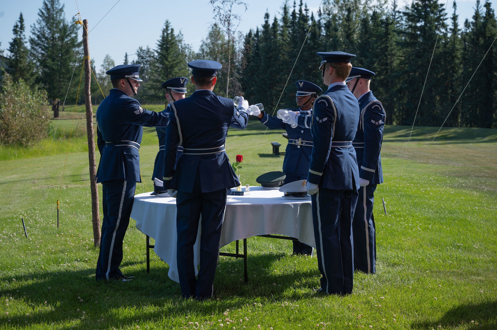 Members of the Eielson Air Force Base Honor Guard turn water glasses upside down during a change of command ceremony at Eielson Air Force Base, Alaska, July 18, 2025.