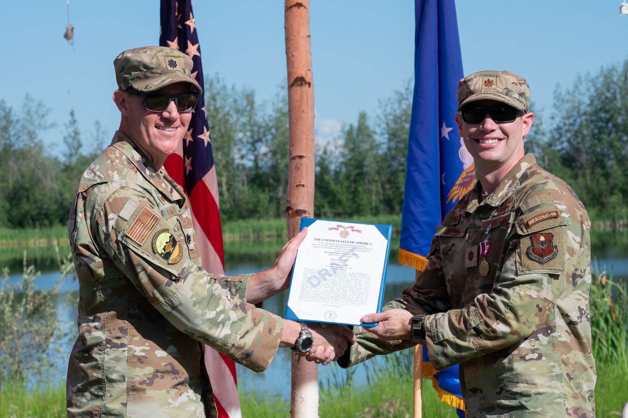 U.S. Air Force Maj. Kaleb Marsh, right, Detachment 1, 66th Training Squadron outgoing commander, receives the Meritorious Service Medal from Lt. Col. Nathan Lowry, 66th TRS commander, during a change of command ceremony at Eielson Air Force Base, Alaska, July 18, 2025.