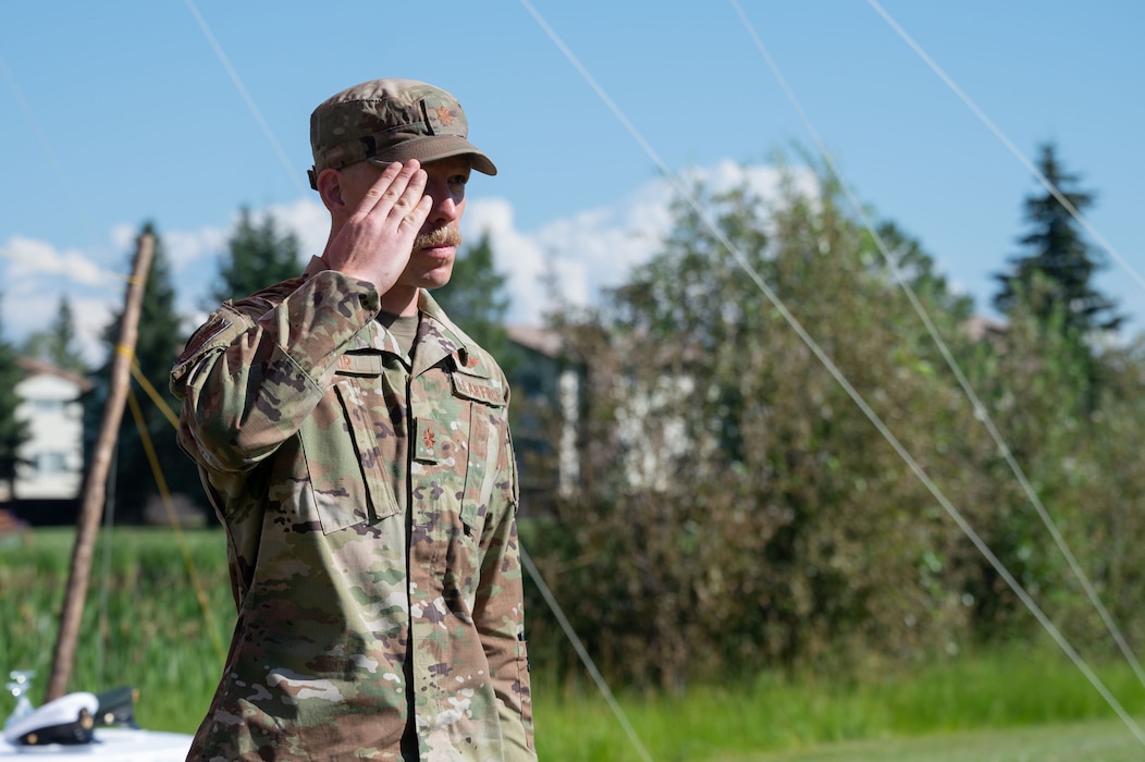 U.S. Air Force Maj. Gordon Blair, Detachment 1, 66th Training Squadron incoming commander, renders an initial salute to Staff Sgt. Ryan Brown, Detachment 1, 66th TRS Survival, Evasion, Reconnaissance, and Escape specialist, during a change of command ceremony at Eielson Air Force Base, Alaska, July 18, 2025.